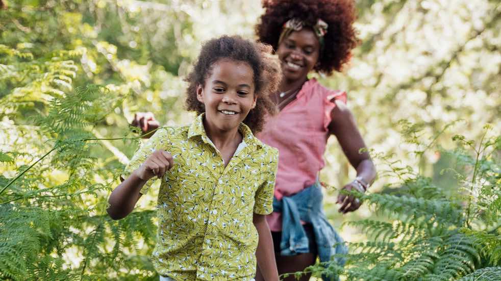 Children running through forest